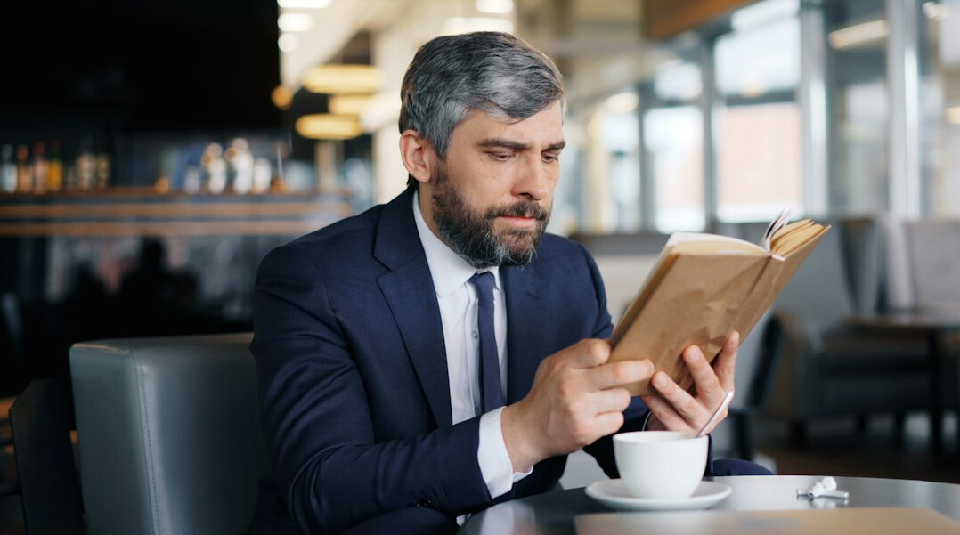 man reading book on communication
