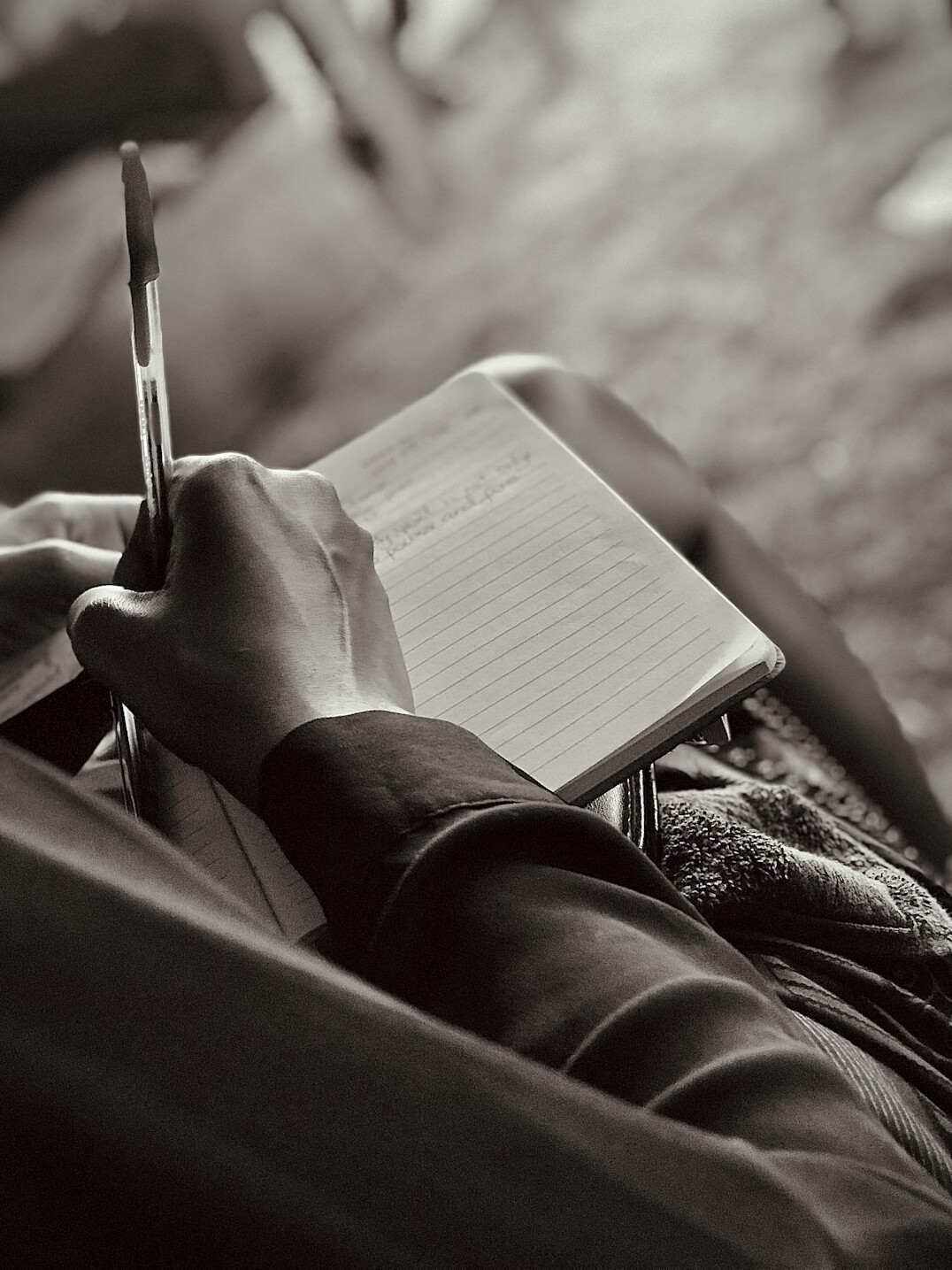 woman writing notes in journal