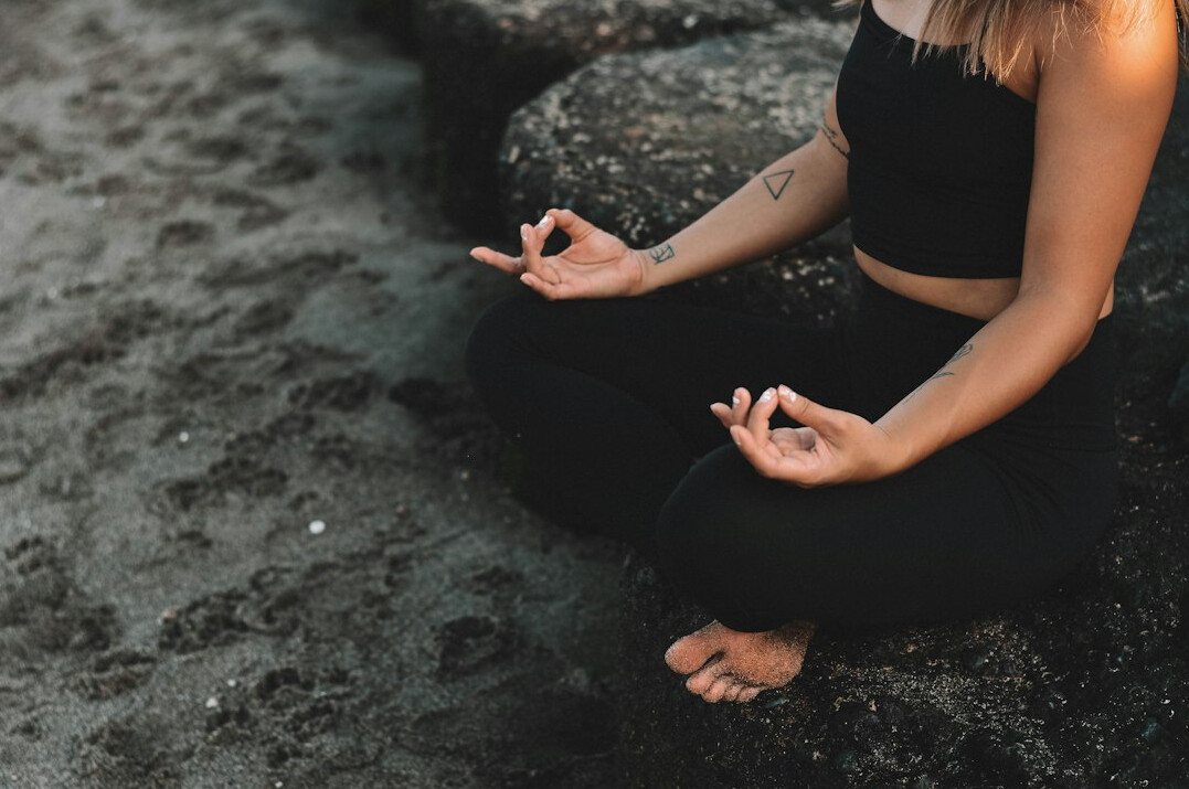 person meditating for wellness