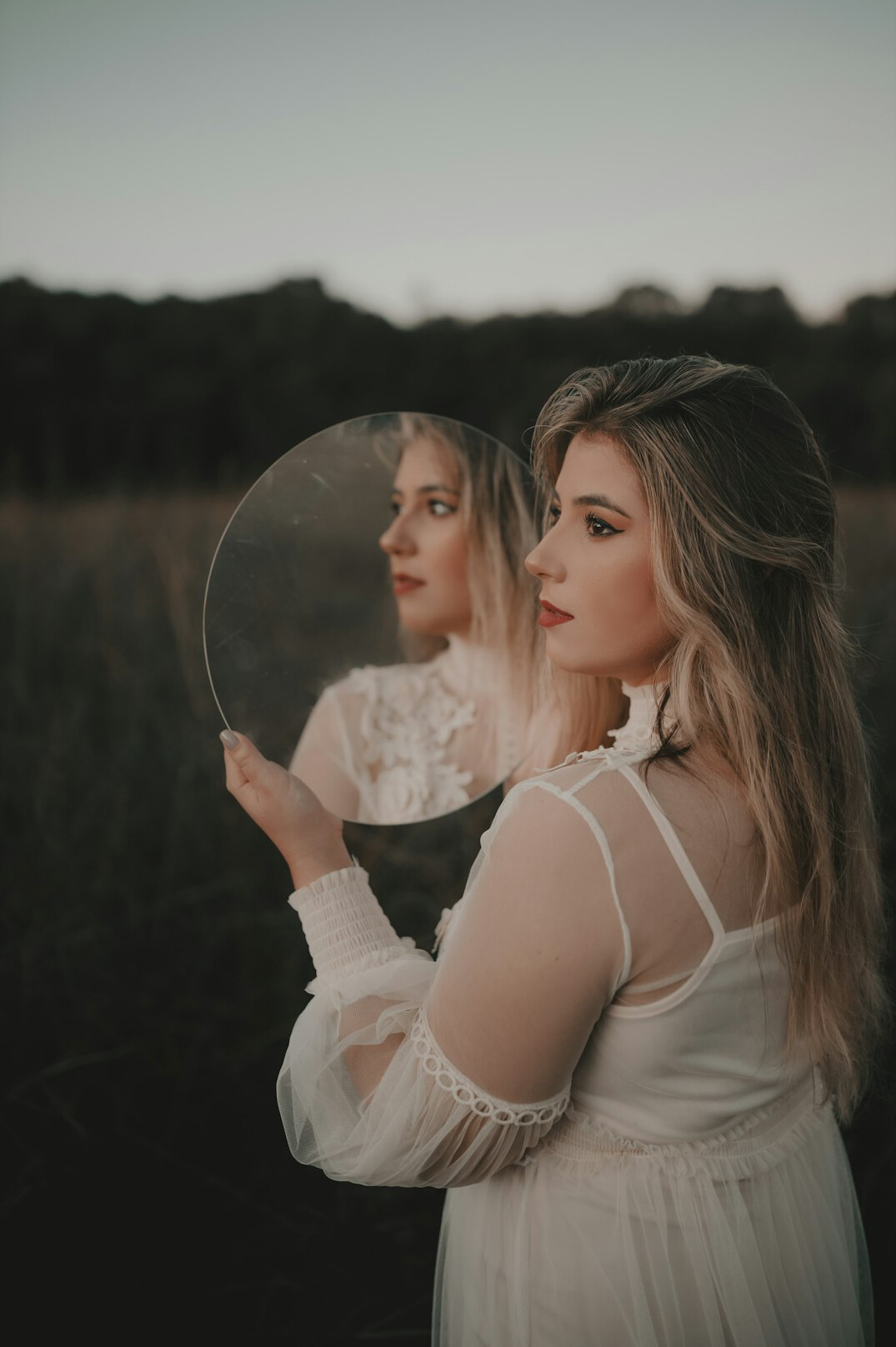 person looking in mirror thoughtfully