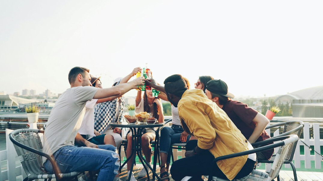 Group of friends having a relaxed conversation around a table